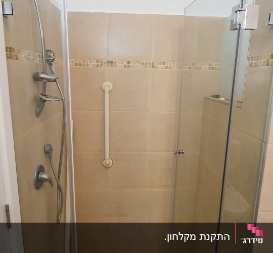 מקלחת עם דלת זכוכית, מוט אחיזה וראש מקלחת
